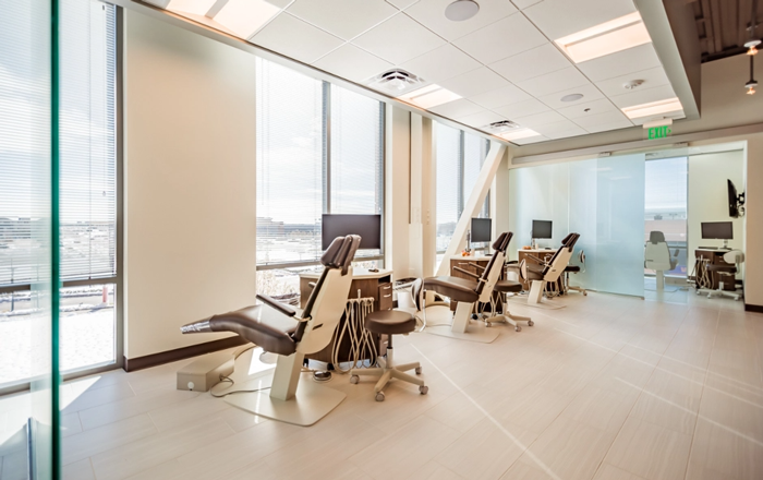 Trommeter Orthodontics | Open orthodontic treatment area with multiple dental chairs and floor-to-ceiling windows.